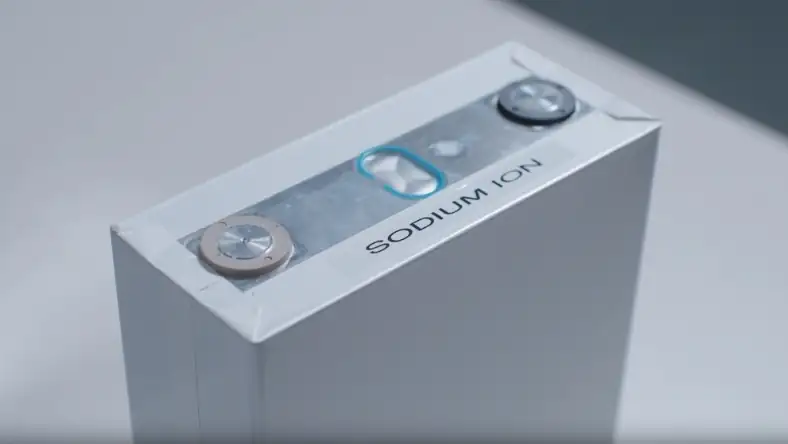 White rectangular sodium-ion battery cell showing two metal terminals and a blue indicator on its top face